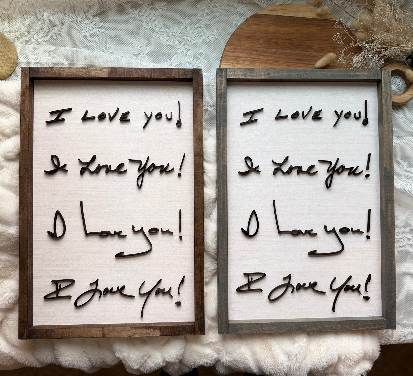 Two framed signs with 'I love you' text on a textured white background