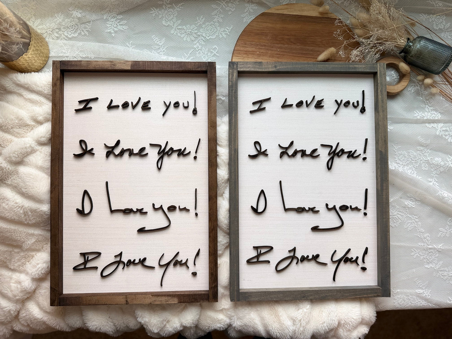 Two framed signs with 'I love you' text on a textured white background