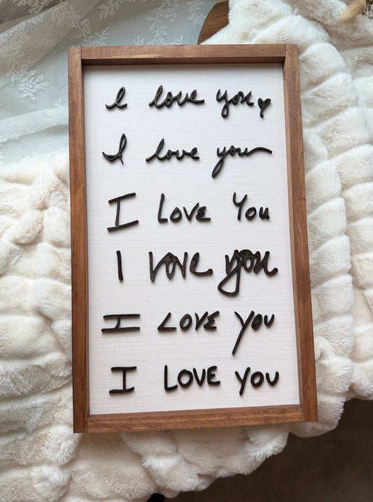 Framed letter board with 'I love you' text on a textured white surface