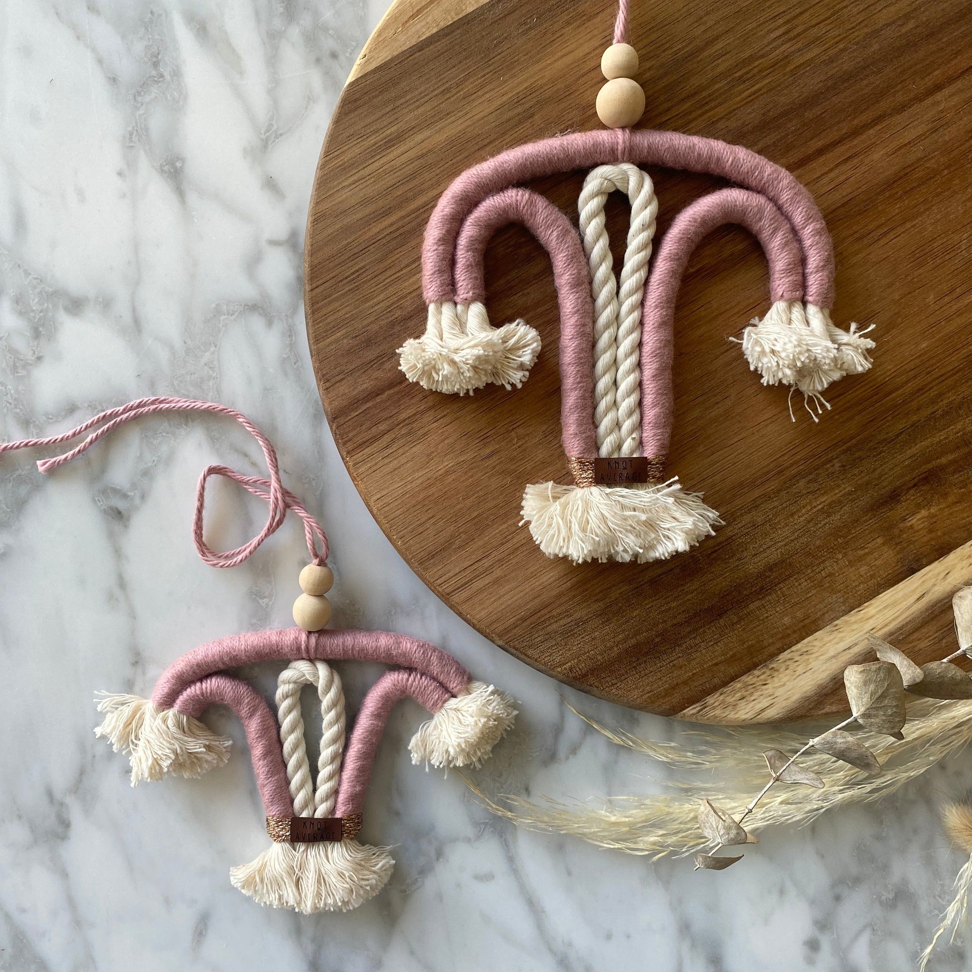 blush colored macrame uterus wall hanging